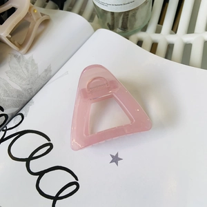 Pink translucent triangle hair claw clip with cutout design and glitter finish