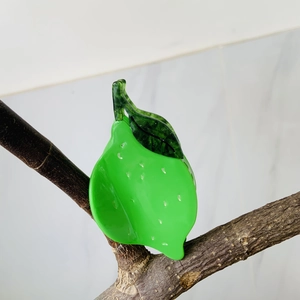 Creative pear-shaped green acetate hair claw clip styled on a natural branch