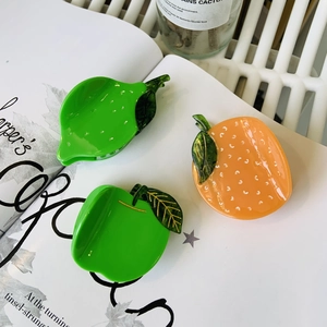 Three-piece set of acetate fruit hair clips featuring lemon orange and apple designs