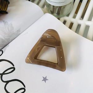 Minimalist triangle hollow hair claw clip in coffee brown with a glossy finish
