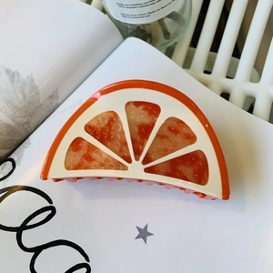 Vibrant orange slice acetate hair claw clip for summer hairstyles and elegant hair styling