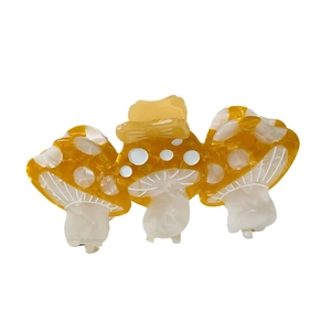 Cute mushroom hair claw clip made of acetate with yellow amber finish and white spots