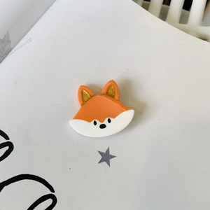 Cute orange and white acetate fox hair claw clip with golden glitter ears on a white base