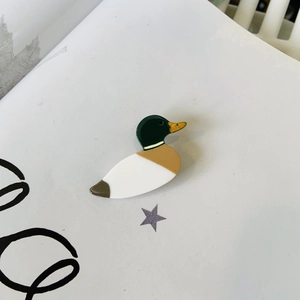 Detailed top view of a colorful mallard duck hair clip made of glossy acetate material