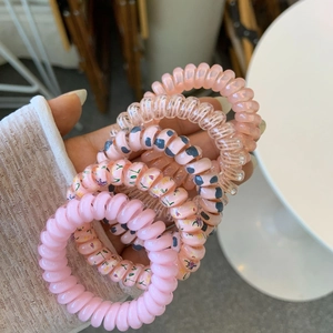 Five pink spiral telephone wire hair ties with floral and polka dot patterns set
