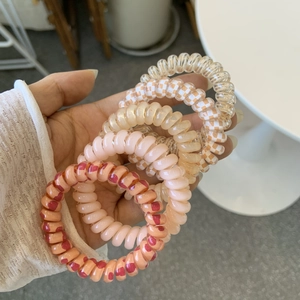 5-piece set of spiral telephone cord hair ties in assorted matte and patterned finishes