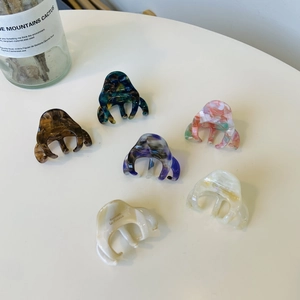 Detail showing various marbled and tortoiseshell patterns on French-style hair claw clips