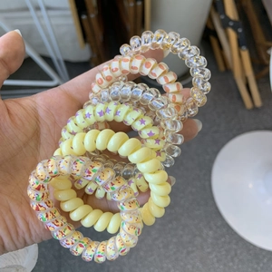 Close-up of assorted spiral telephone cord hair ties in various colors and patterns