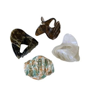Elegant acetate hair claws in tortoise shell, pearl white, and floral patterns set