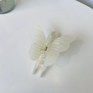 Iridescent acetate butterfly hair claw clip with golden spring in pearly cream white