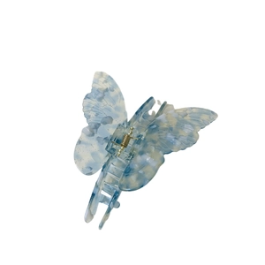 Elegant butterfly hair claw clip in light blue marbled acetate with subtle glitter