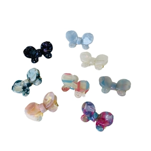 Set of 8 colorful acetate bow hair clips with rhinestones in various patterns and marble tones