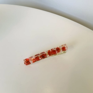 Elegant gold hair clip with red flowers preserved in clear resin cubes for women