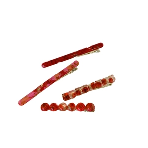 Elegant four-piece set of red floral hair clips with gold alloy duckbill clips on white base