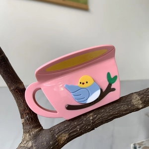 Close-up of pink cup-shaped hair claw clip with 3D bird motif and glossy finish