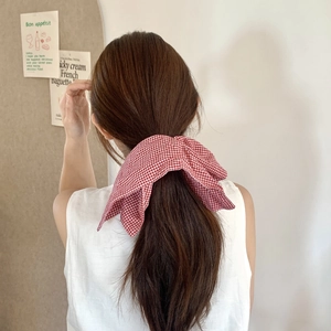 Red gingham oversized hair scrunchie shown in a stylish low ponytail hairstyle