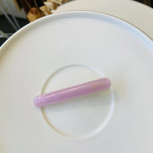 Close-up of pink thickened duckbill hair clip with golden Barrette La France lettering