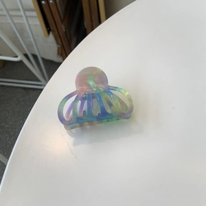 Detailed macro shot of the colorful gradient acetate hair claw with Creation France carving