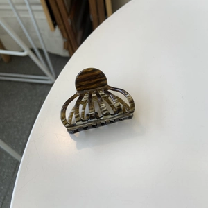 Detail of tortoise shell acetate hair claw clip showing Creation France engraving