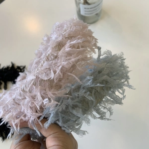 Detail showing the fluffy texture of pink, blue, and black feather headbands