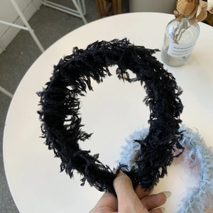 Classic black feather headband for women with elegant textured fluffy finish