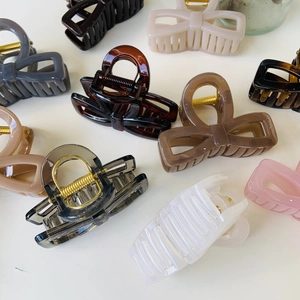 Variety of elegant resin bow and square hair claw clips in neutral and pastel colors