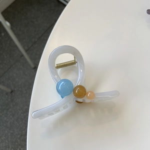 Translucent white resin hair claw clip with colorful beads and gold metal spring