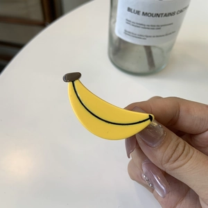 Creative yellow banana shaped hair clip in candy color with glossy finish and realistic detail