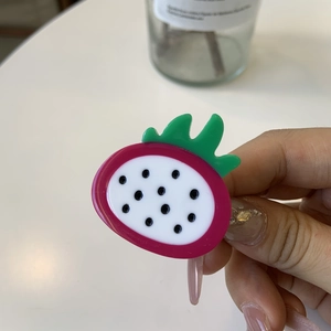 Detail view of pitaya dragon fruit acetate hair clip with pink and green details