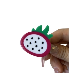 Handcrafted dragon fruit shaped acetate hair clip with bright pink and green colors