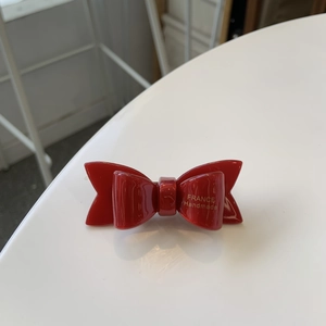 Elegant red acetate double bow hair clip with golden France Handmade logo lettering