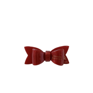 Polished red acetate bow hair clip with gold France Handmade logo on white background