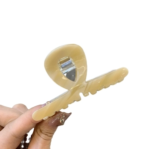 Cross-shaped marble milk tea hair claw clip with golden lettering and silver spring