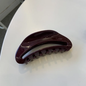 Elegant deep burgundy acetate hair claw clip with a glossy finish for hair styling