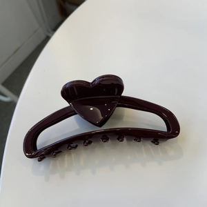 Dark red heart-shaped acetate claw clip with a glossy finish for elegant high ponytails