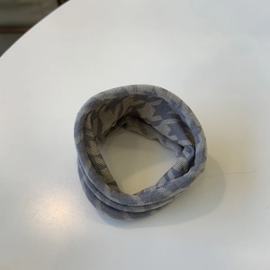 Knitted winter snood scarf in grey and white melange with ribbed texture for warmth