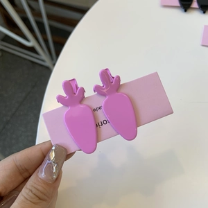 Pink carrot shaped acetate hair clips for girls featuring glossy finish and metal clip