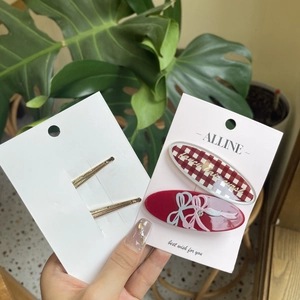 Sweet checkered and bow pattern acrylic hair clips set on display for girls