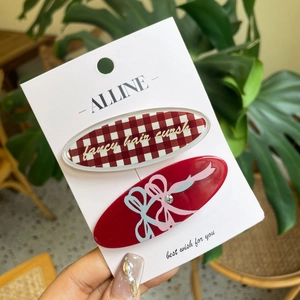 Red checkered and solid red bow hair clip set with rhinestones on display card