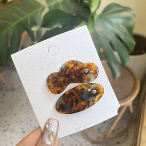 Detail of tortoise shell acetate hair clips with small rhinestones on display card