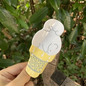 Dettaglio di un fermaglio per capelli a forma di gelato con finitura gialla lucida