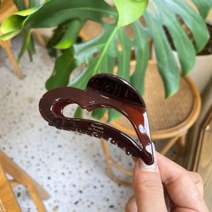 Brown acetate heart-shaped hair claw clip with golden Barrette La France lettering