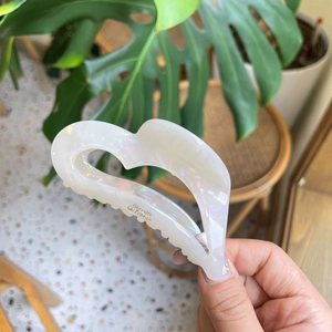 Iridescent cream acetate heart hair claw clip for women's bun hairstyle