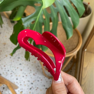 Detailed view of a pink heart acetate hair claw with Barrette la France golden lettering