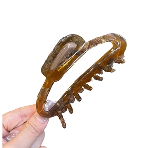 Hollow acetate shark hair claw clip in amber tortoiseshell pattern for high ponytail styles