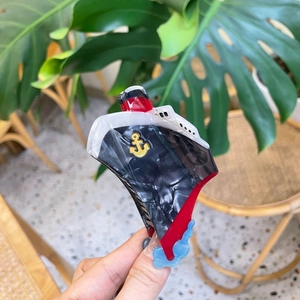 Creative acetate hair claw in cruise ship design with black, white, and red marble texture
