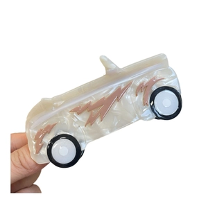 Cute car-shaped acetate hair claw clip with pearl white finish and pink lightning