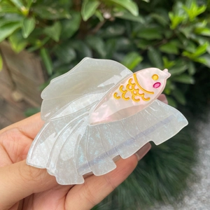 Detailed close-up of a pearlescent white acetate Betta fish hair claw clip with blue glitter