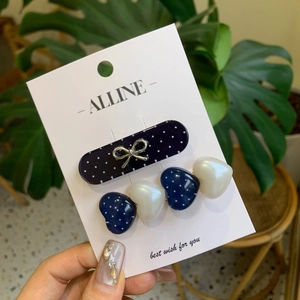 Sweet navy polka dot heart and bow hair clip set on a white display card