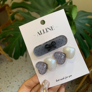 Chic grey polka dot hair clips with black bows and pearlescent heart shapes for women